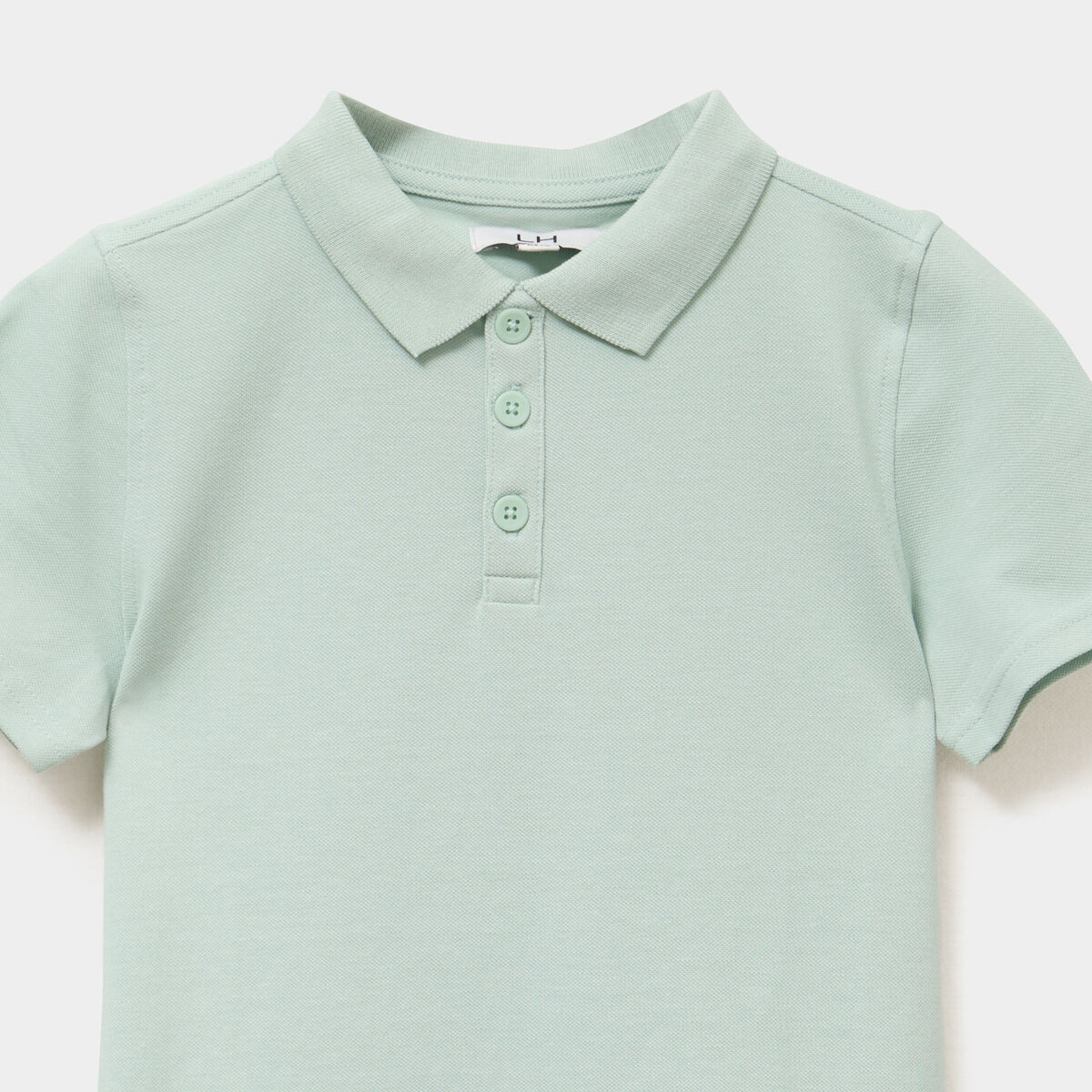 Polo manches courtes à détail brodé vert pastel garçon